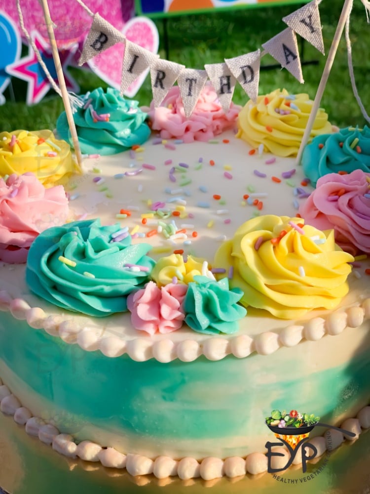 Black forest Birthday cake with pastel color finish and banner.