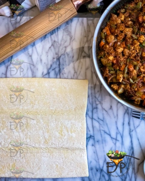 Thawed puffpastry sheet and tandoori filling ready to be filled.